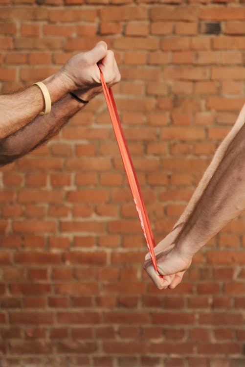 Adult performing a functional exercise that mimics everyday carrying movement