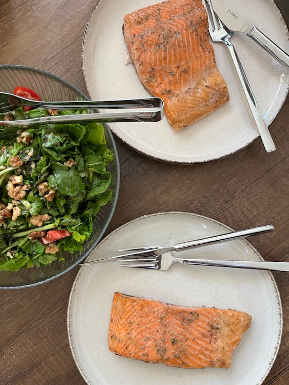 Healthy protein-rich meal with grilled salmon, eggs, and vegetables on a kitchen table