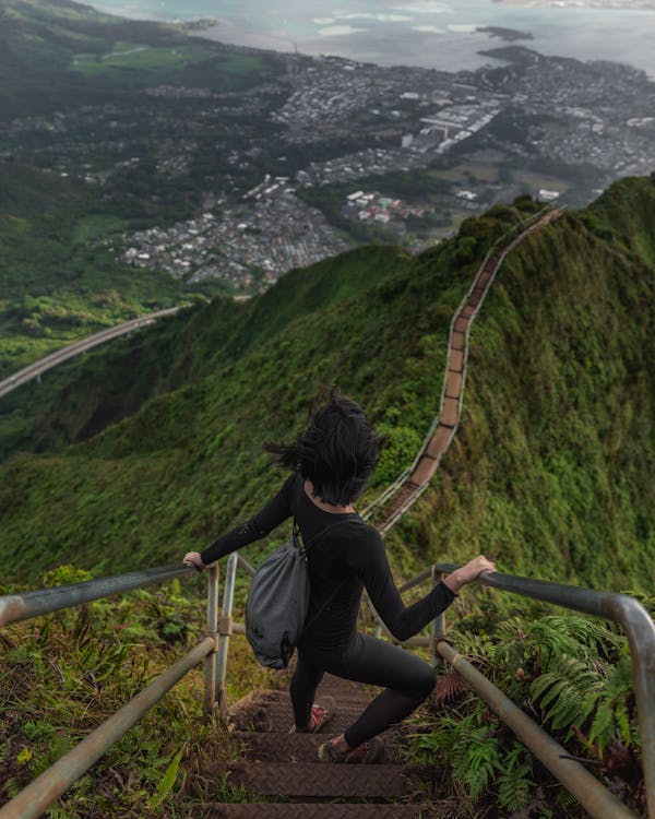 Adult confidently ascending stairs while holding a handrail